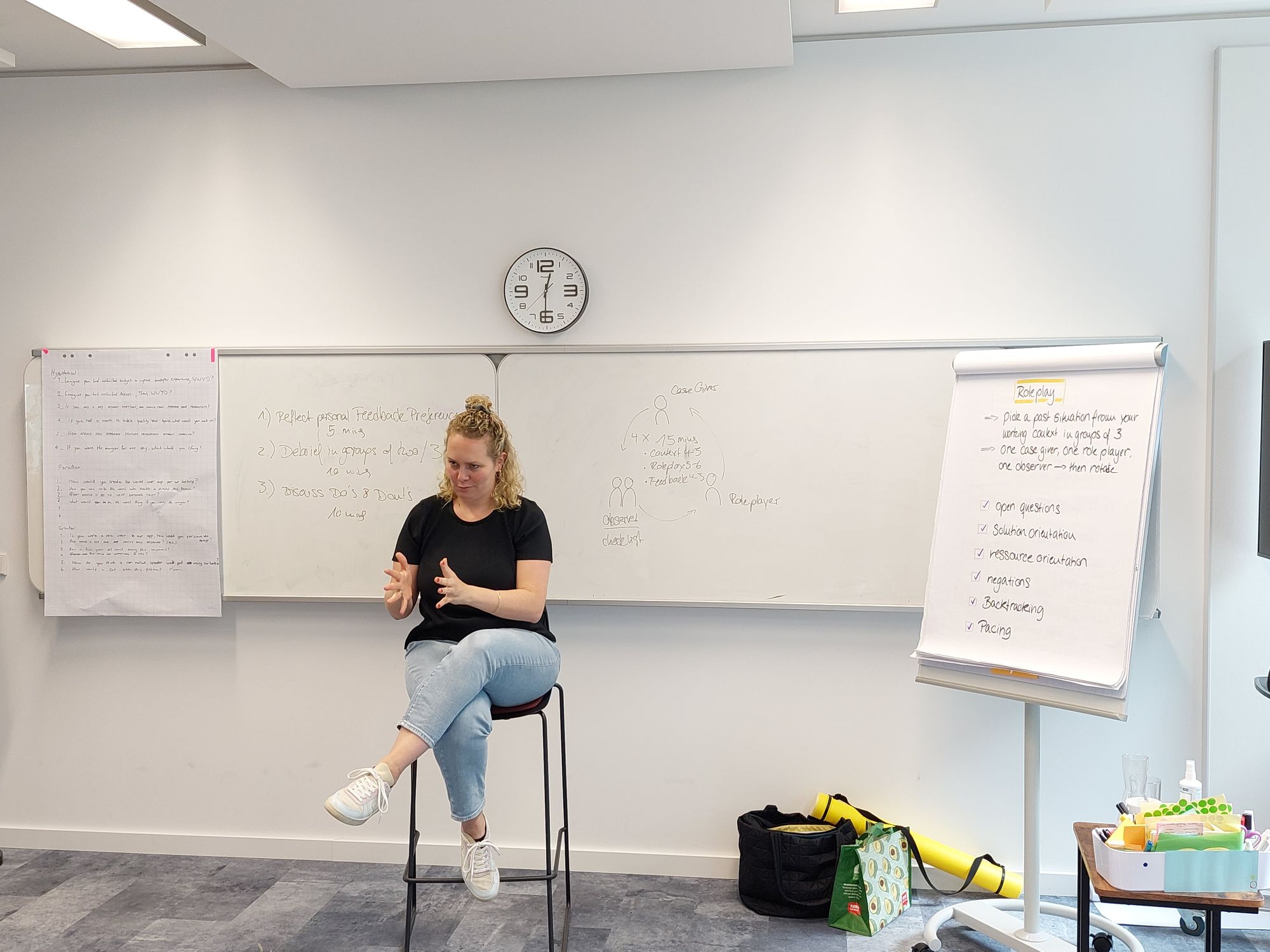 the trainer of the workshop sits on a high chair explaining content